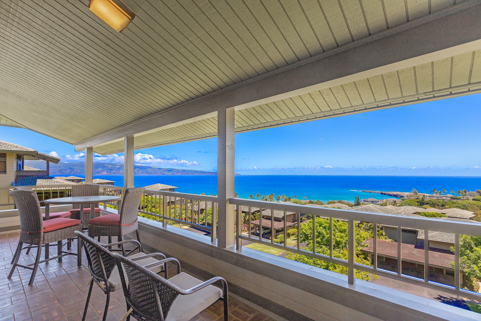 Lahaina Vacation Rentals, Kapalua Ridge 1622 - Enjoy sweeping ocean views from this spacious, covered lanai, where stylish tile flooring complements the home's first floor. It's the perfect spot to relax in the shade, savoring tropical breezes in ultimate comfort.