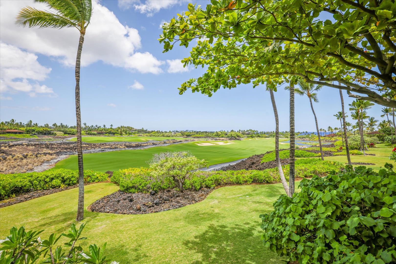 Kailua Kona Vacation Rentals, Wai'ulu Villa 115D - Palm-studded grounds and sweeping green views from the villa’s edge—true island elegance.