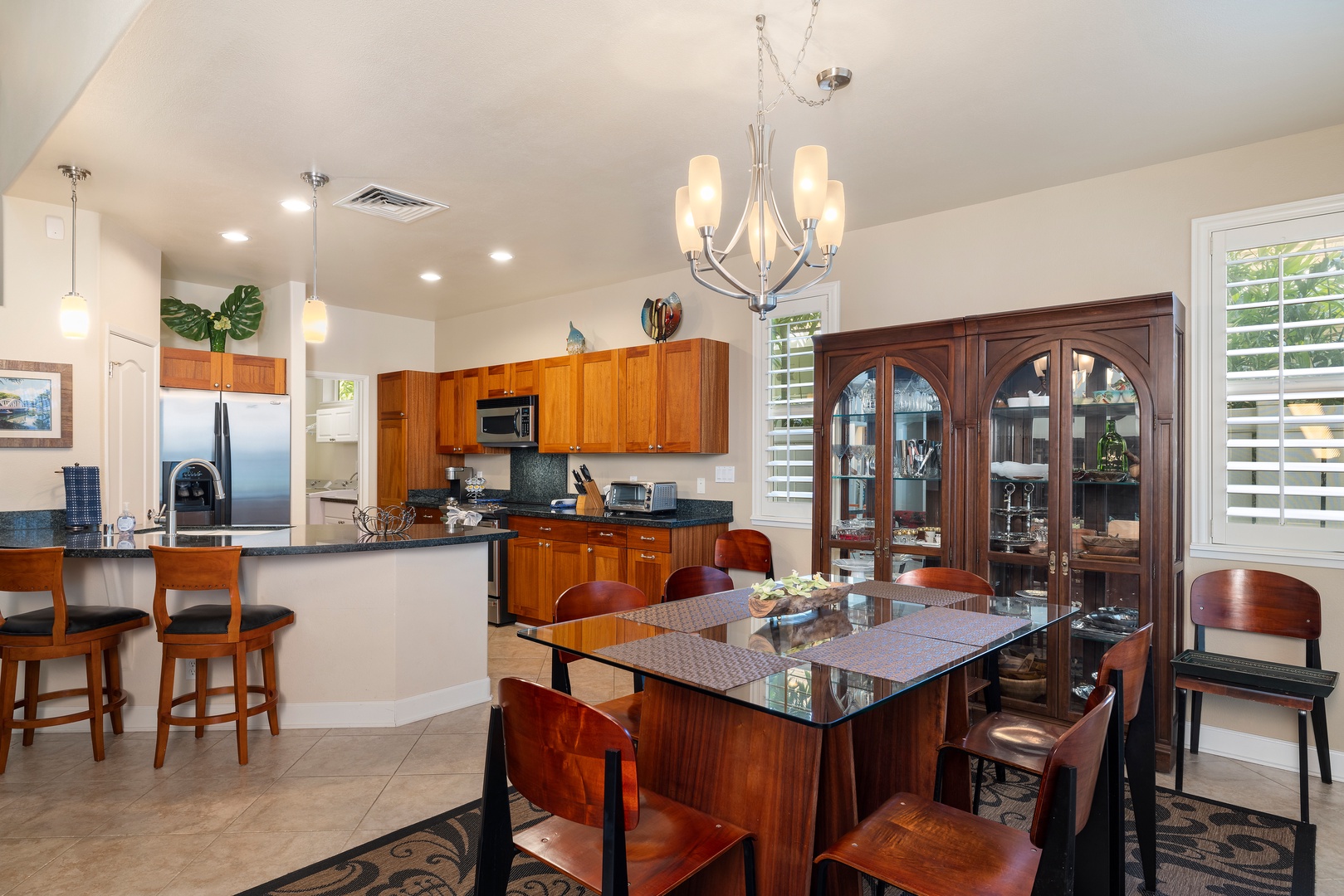 Cook together in this elegant kitchen featuring rich wood cabinetry, granite countertops, and a spacious island perfect for meal prep and casual dining.
