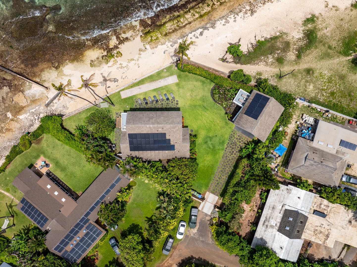 Waianae Vacation Rentals, Ma'ili Blue Estate - The oceanfront estate has solar panels nestled between lush tropical landscaping and pristine sandy shores.