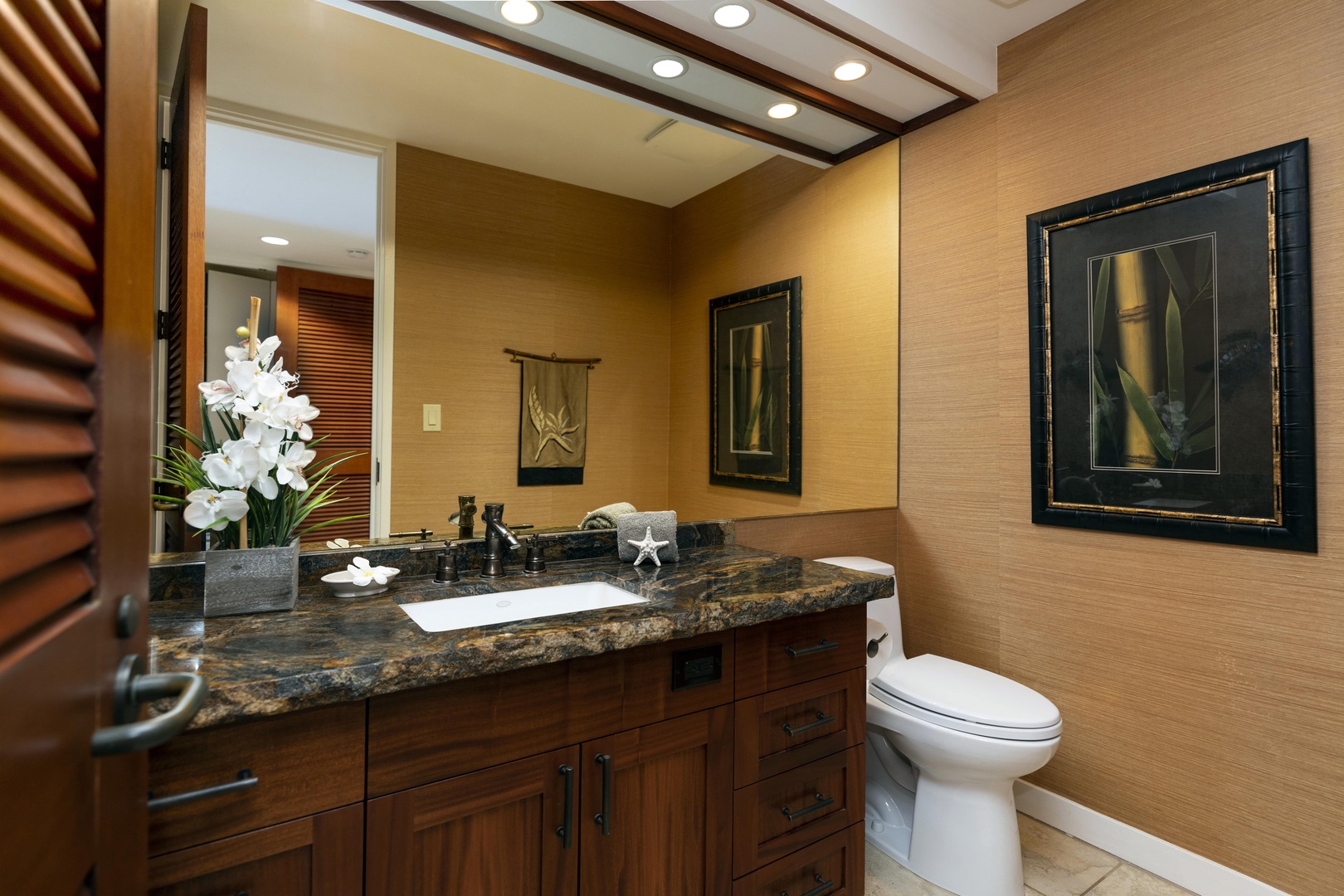 Kamuela Vacation Rentals, Mauna Lani Point E105 - A stylish half bath located just off the front entry offers added comfort and convenience for visiting guests.