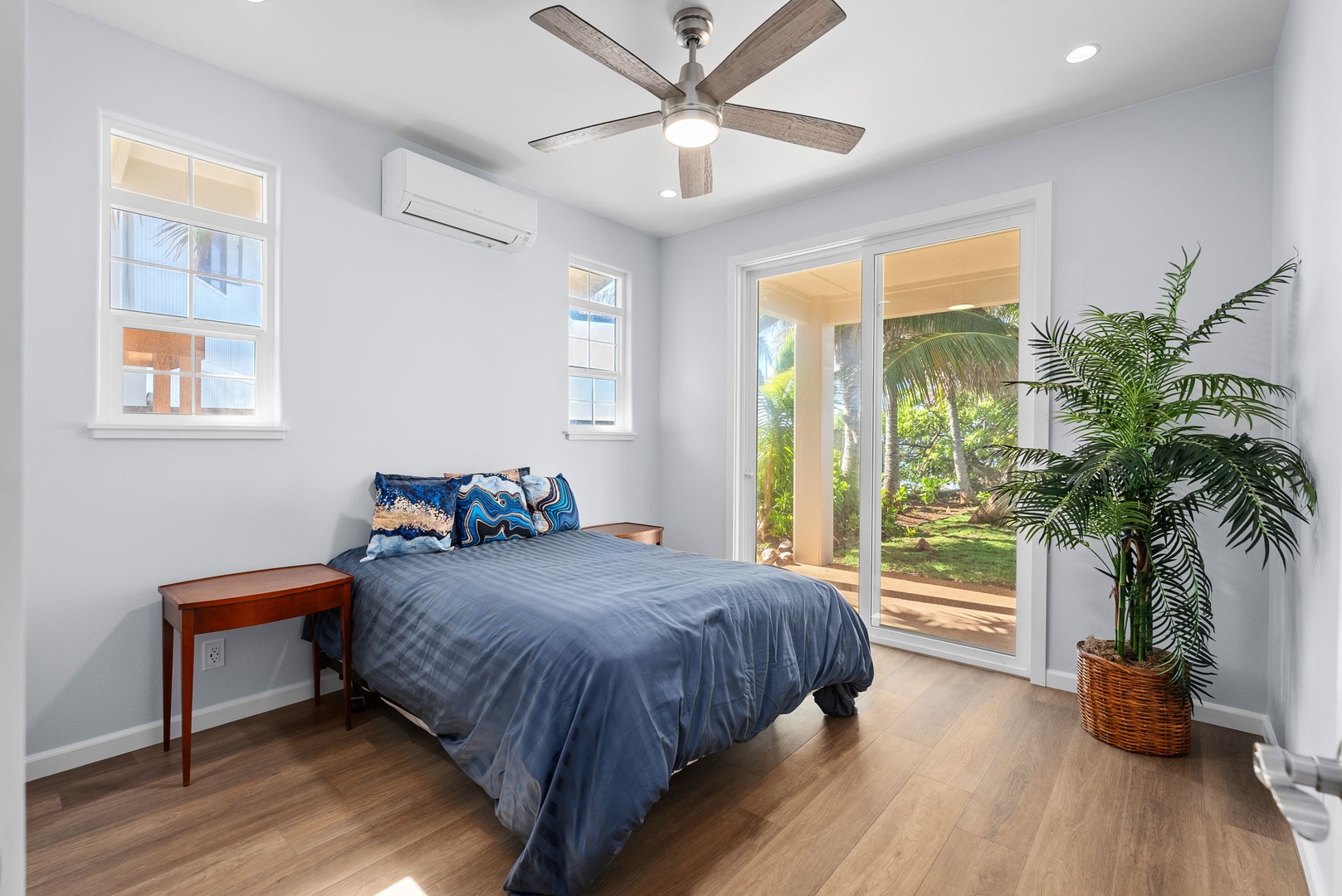 Waianae Vacation Rentals, Oceanfront Luxury Dream Estate - The ground-floor guest suite with contemporary furnishings, ceiling fan, and plush bedding.