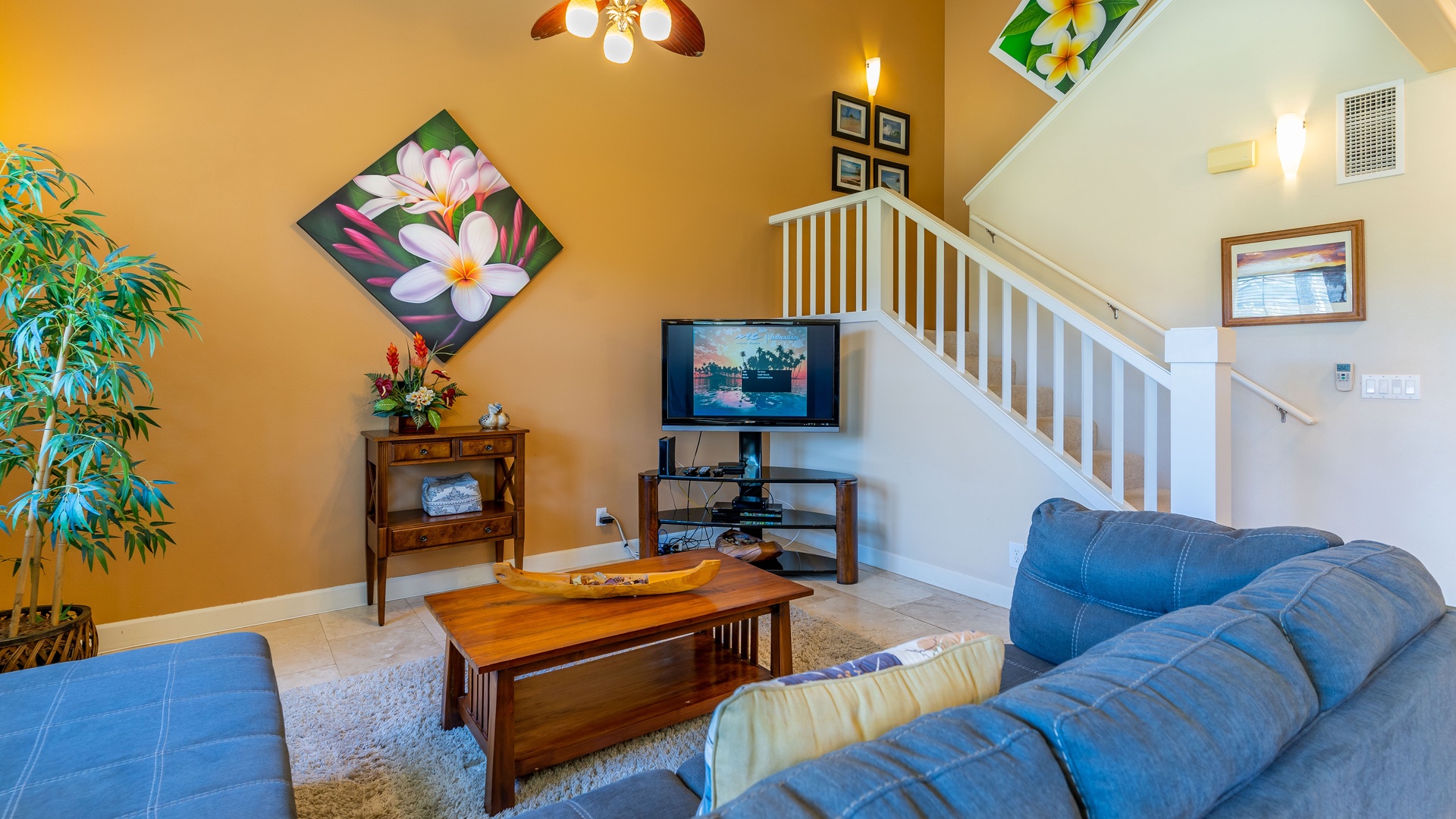 Kapolei Vacation Rentals, Ko Olina Kai 1033C - Relax for movie night on TV in the plush living area near the stairs.