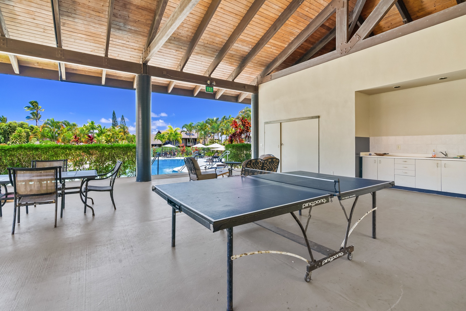 Princeville Vacation Rentals, Mauna Kai 7B - The ping pong table takes center stage in the pavilion, with the community pool just beyond it.