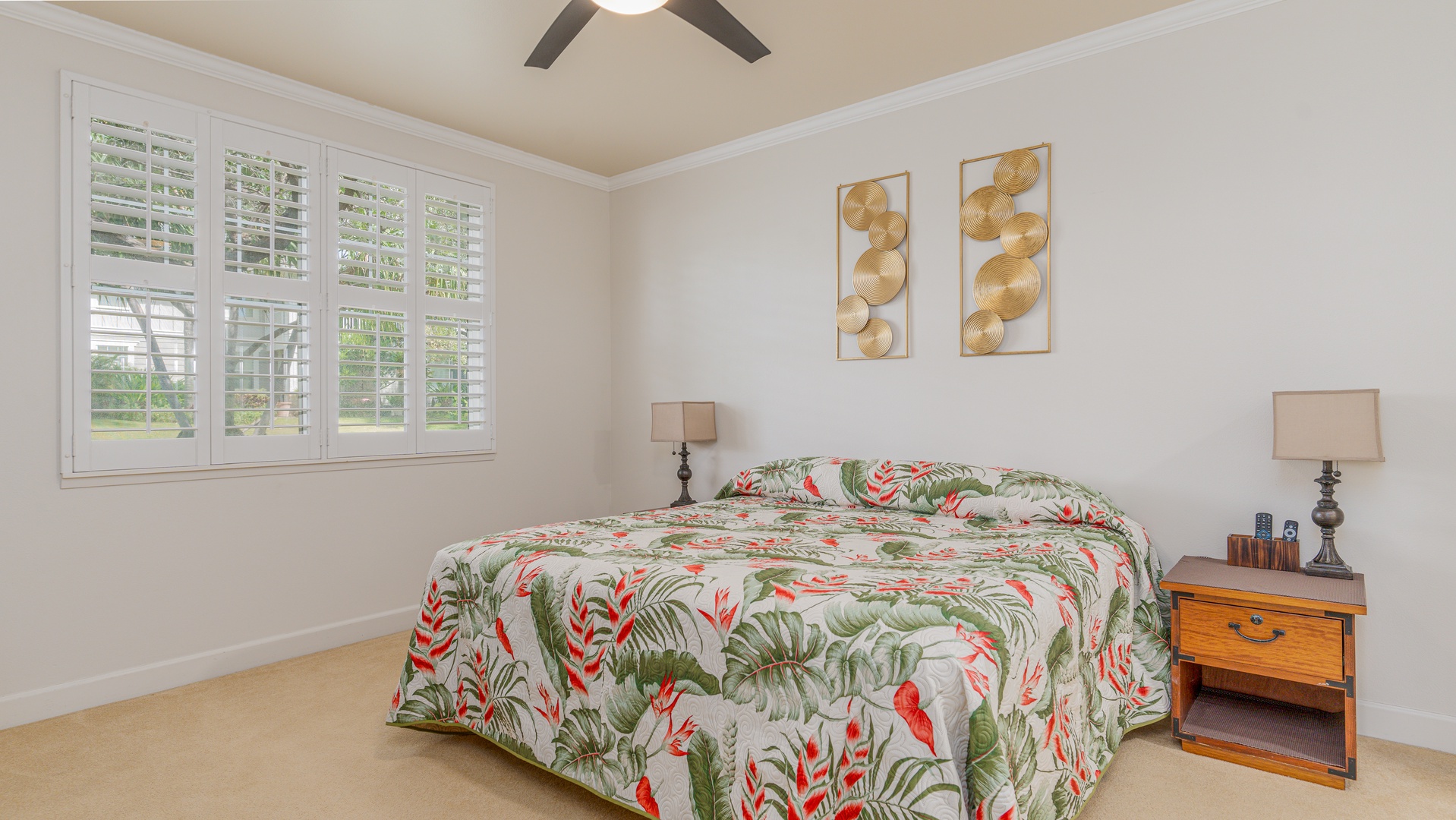 Kapolei Vacation Rentals, Ko Olina Kai 1027A - The spacious primary guest bedroom with a TV and scenery.