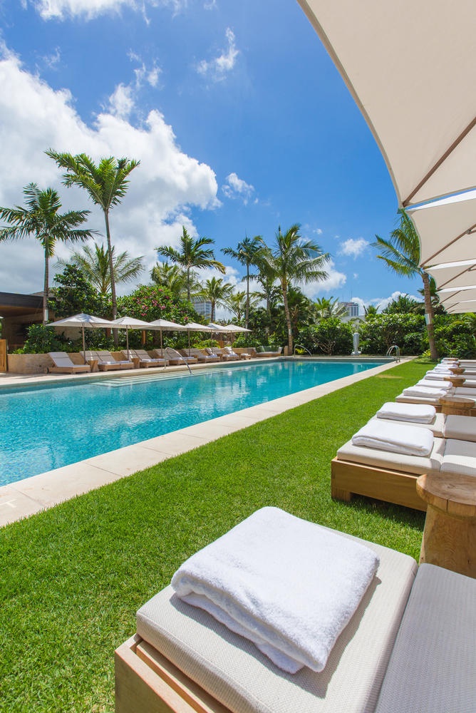 Honolulu Vacation Rentals, Park Lane Sunset Resort - Dive into crystal-clear waters surrounded by swaying palms and plush loungers where tropical luxury meets your perfect poolside retreat.