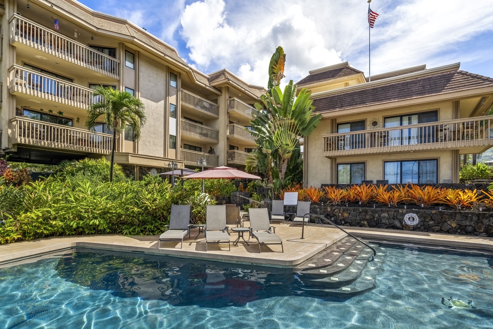 Kailua Kona Vacation Rentals, Royal Kahili 401A - A serene poolside oasis with tropical landscaping.