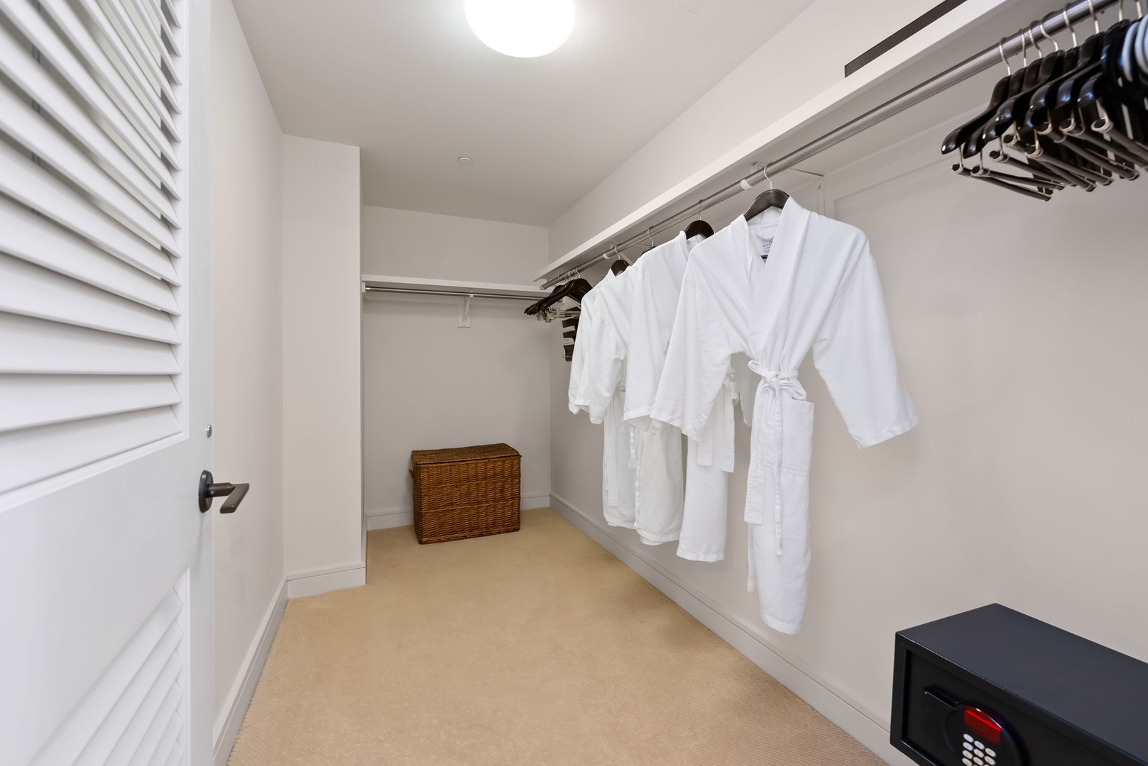 Honolulu Vacation Rentals, Kala'i 3203 - Spacious primary walk-in closet with plush robes, offering ample storage for a comfortable stay.