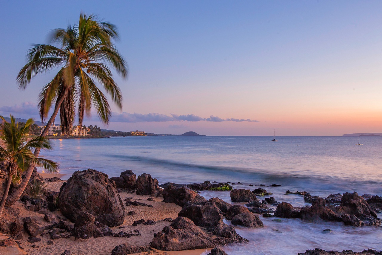 Kihei Vacation Rentals, Kamaole Beach Royal 610 - Evening color settles over the lava rock shoreline as the palms go still.