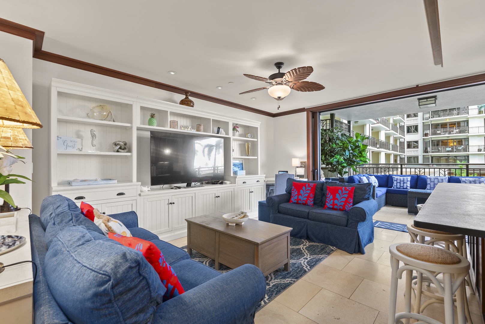 Sink into the sofa with the lanai doors open and the living room stretches outside.