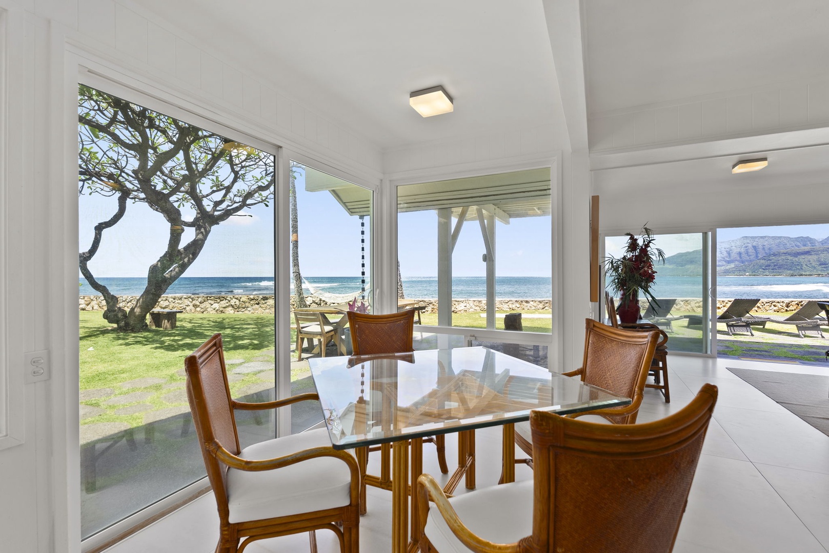 Waianae Vacation Rentals, Ma'ili Blue - Savor your meals with breathtaking ocean views from your bright dining area, where floor-to-ceiling windows frame the sea perfectly.