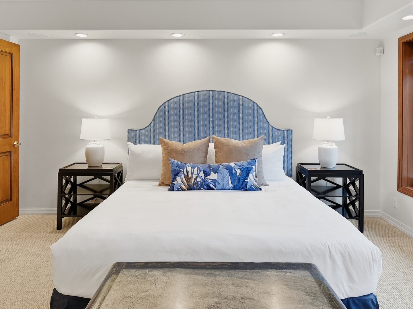 Honolulu Vacation Rentals, Maunalua Estate - Sink into crisp white linens and plush pillows in your elegant bedroom, where coastal blues and warm lighting create the perfect retreat.