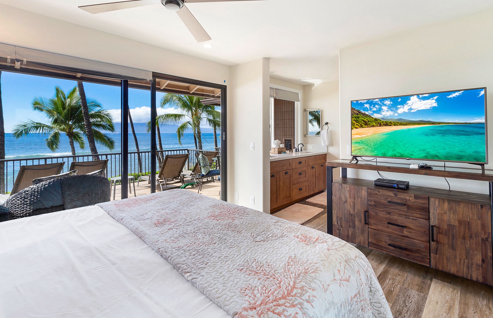 Lahaina Vacation Rentals, Puamana 240-3 - Relax in this elegant bedroom featuring a luxurious king-size bed and stunning oceanfront views.