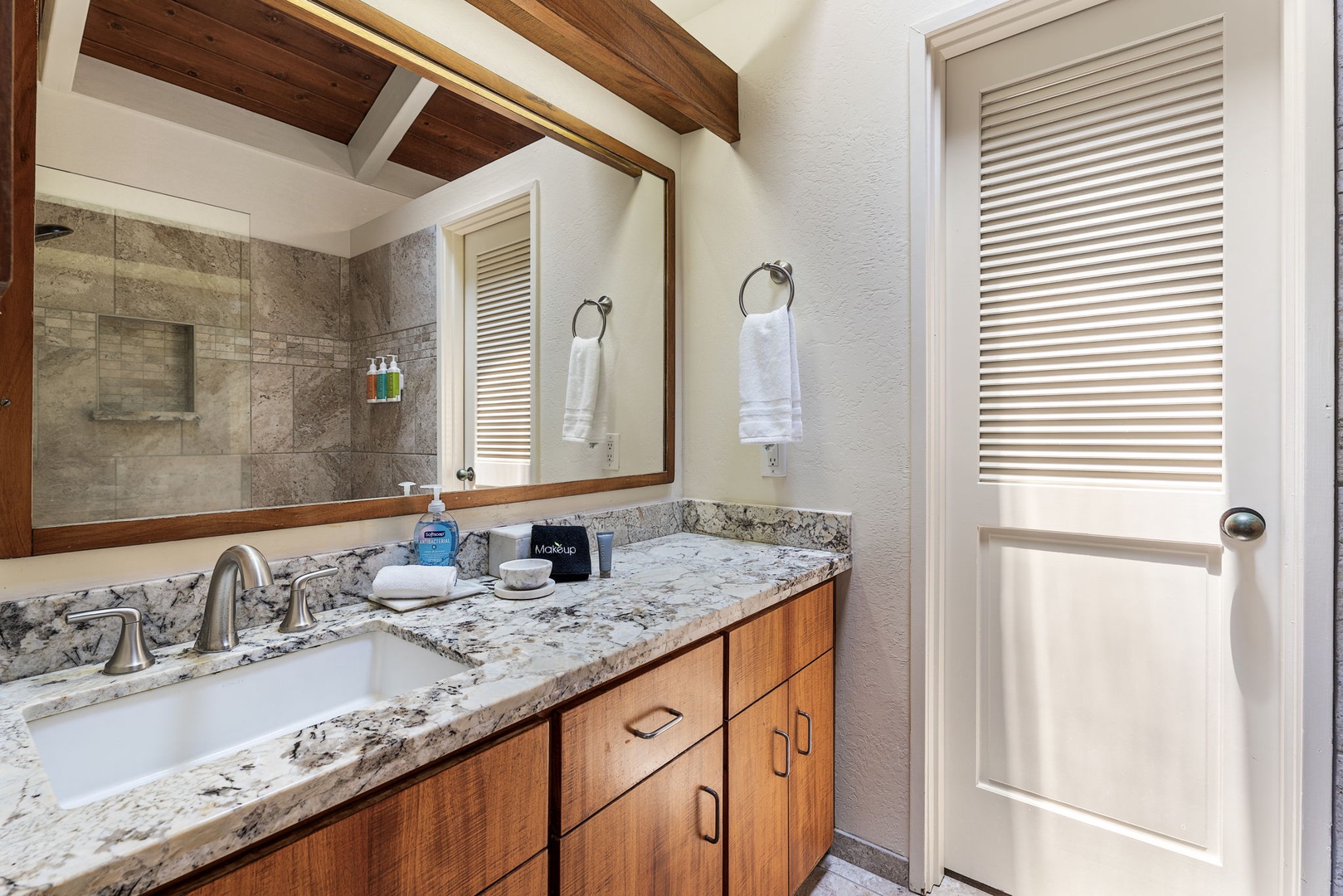 Kailua Kona Vacation Rentals, Kanaloa at Kona 1606 - Granite vanity and warm wood, finished under a beamed ceiling.