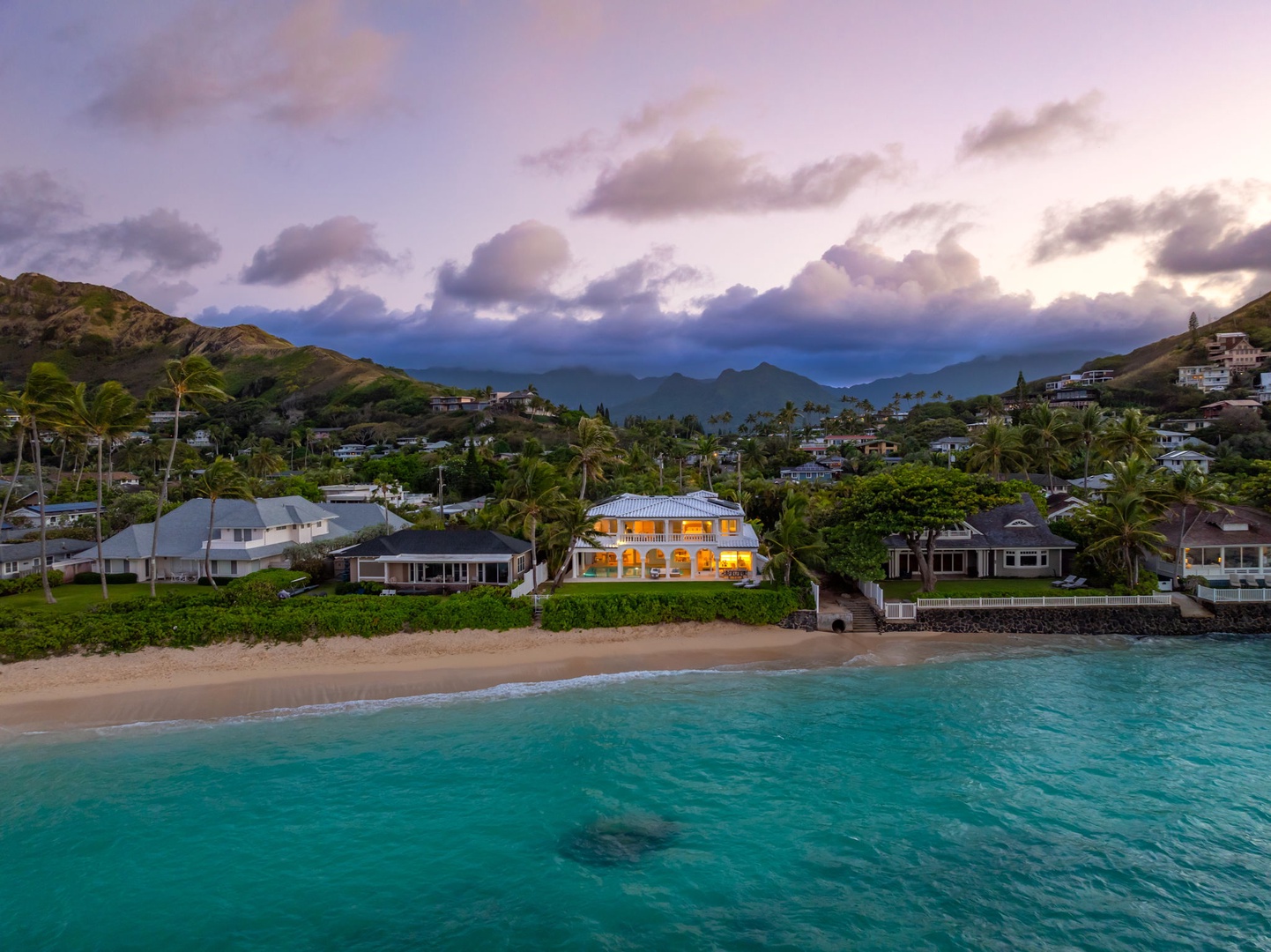 Kailua Vacation Rentals, Lanikai Sunrise Estate - A serene twilight aerial of Mokulua Sunrise Estate as it glows against the lush Lanikai hillside.
