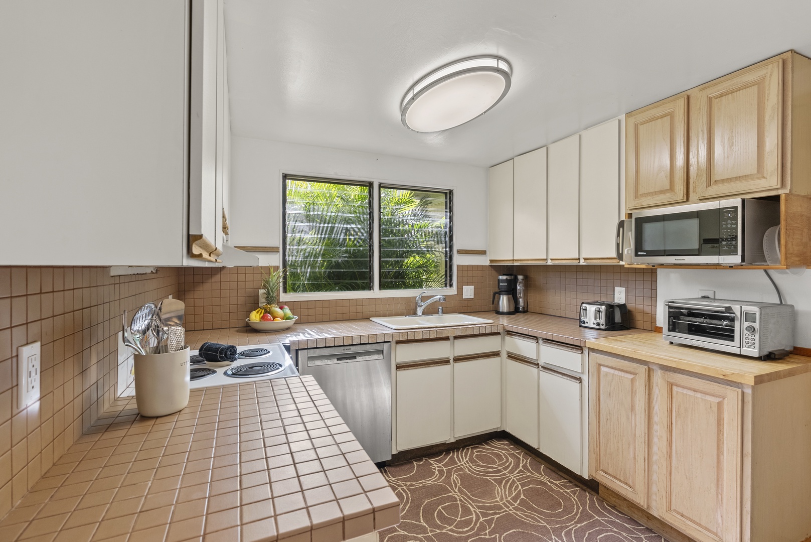 Haleiwa Vacation Rentals, North Shore Beachfront Retreat - Fully equipped kitchen with ample counter space and natural light.