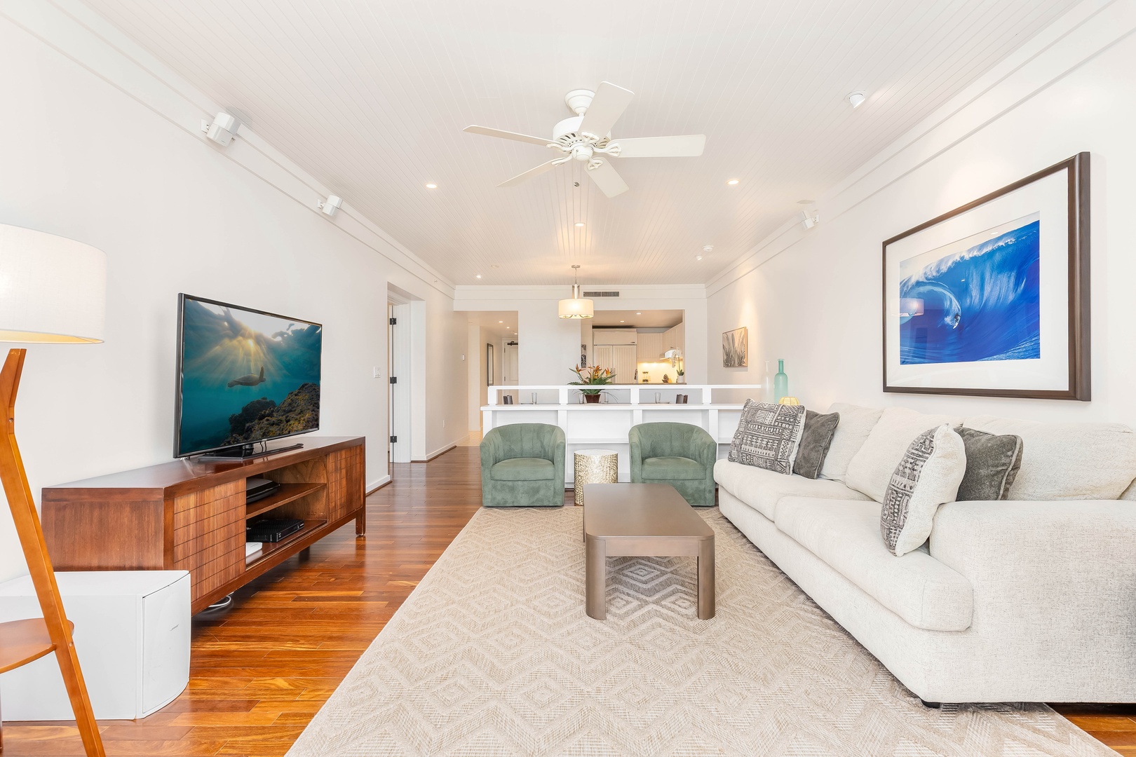 Kahuku Vacation Rentals, Turtle Bay Villas 209 - Stylish living space with ocean-inspired artwork, plush seating, and modern coastal touches throughout.
