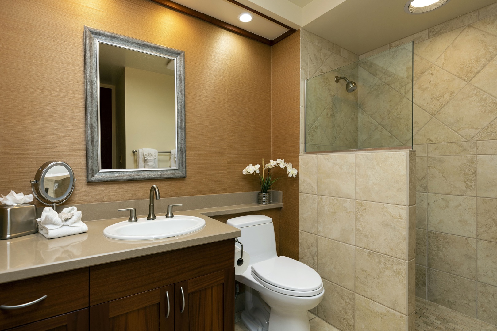 Kamuela Vacation Rentals, Mauna Lani Point E105 - The guest bathroom offers a walk-in shower and elegant design elements for a spa-like experience.
