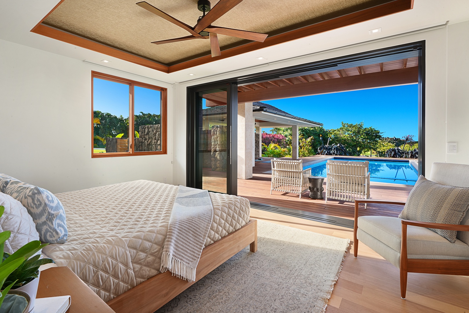 Koloa Vacation Rentals, Hale Kai'Opua - Guest bedroom with a king-size bed and direct access to the pool deck.