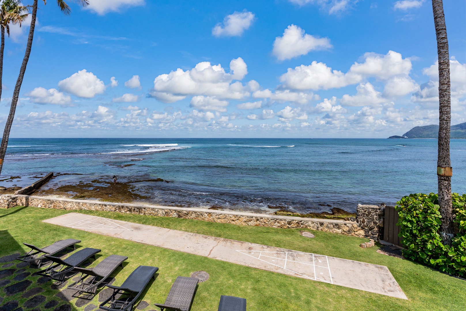Waianae Vacation Rentals, Ma'ili Blue - Oceanfront property featuring pristine lawn areas, loungers, and direct beach access with crystal-clear waters and tropical surroundings.