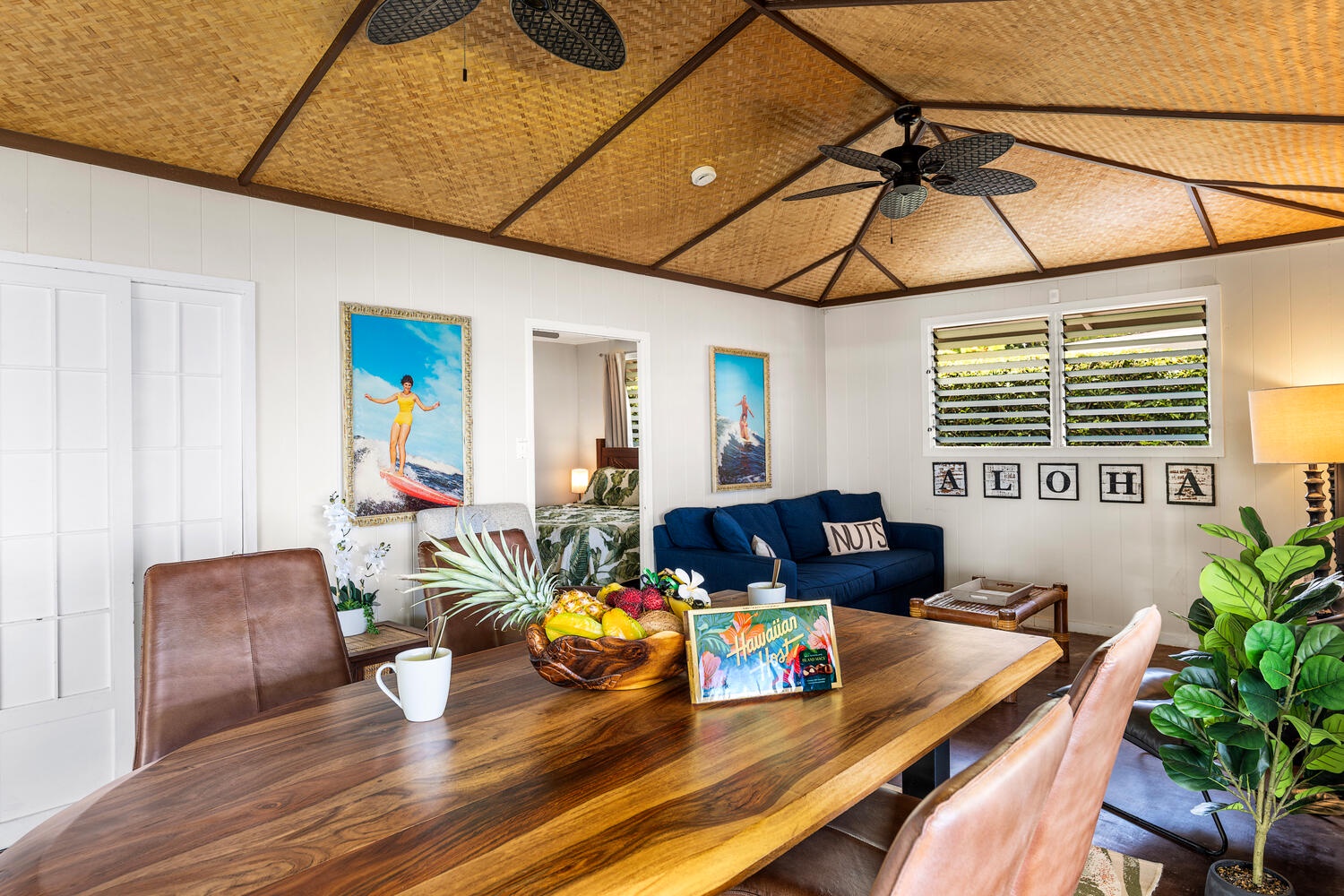 Kailua Kona Vacation Rentals, Honl's Beach Hale (Big Island) - Indoor dining table set beneath woven ceilings, blending style with island charm.