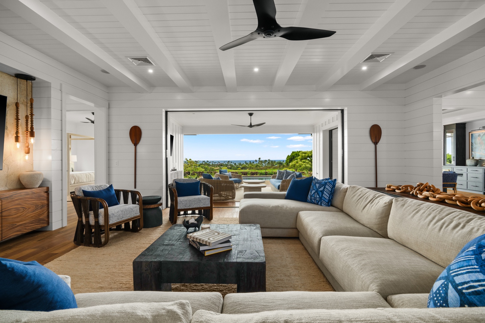 Koloa Vacation Rentals, Makani Kai - Afternoon light pools in the main room across a deep sectional and open doors.