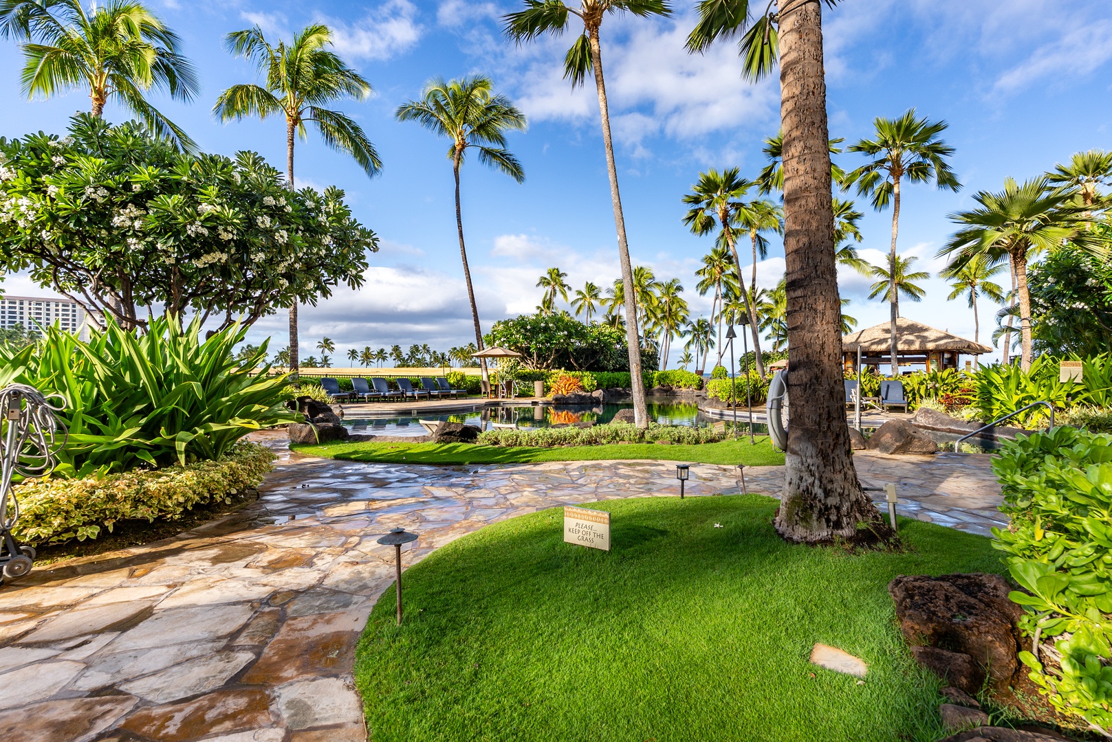 Follow the flagstone paths between the buildings, all lawn and palms.