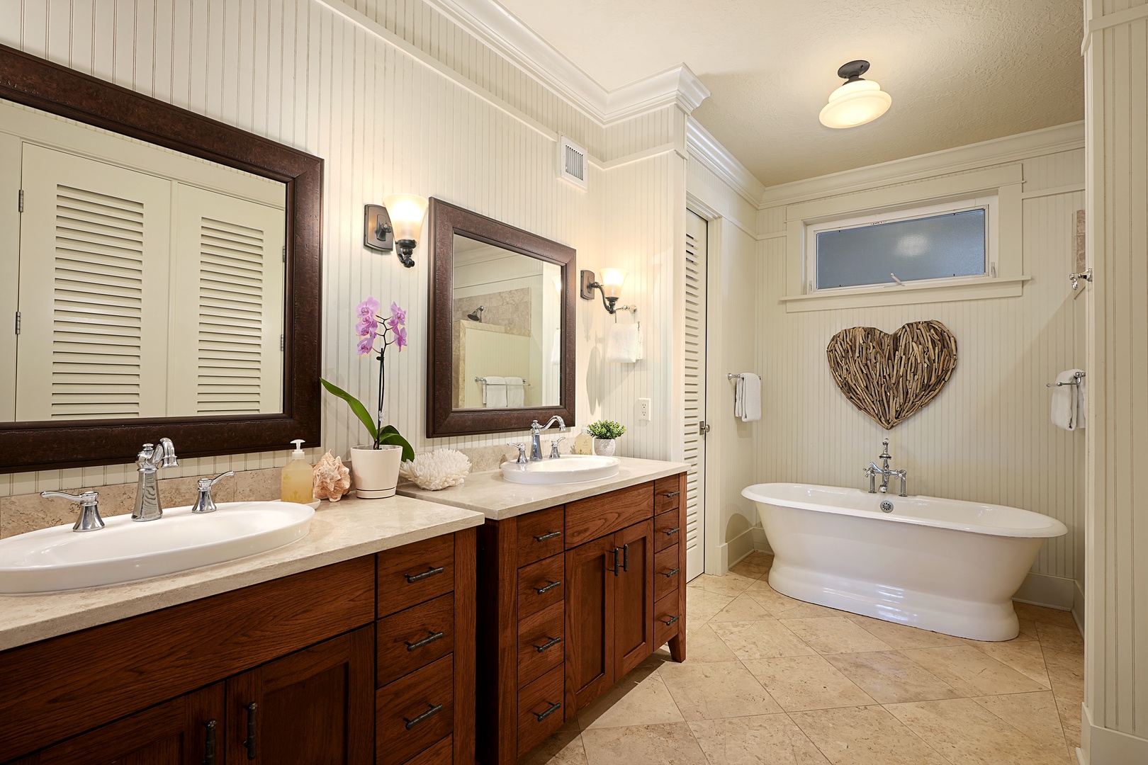 Koloa Vacation Rentals, Villas at Poipu Kai B111 - Ensuite bathroom with dual sinks, a soaking tub, and elegant décor for a spa-like retreat.