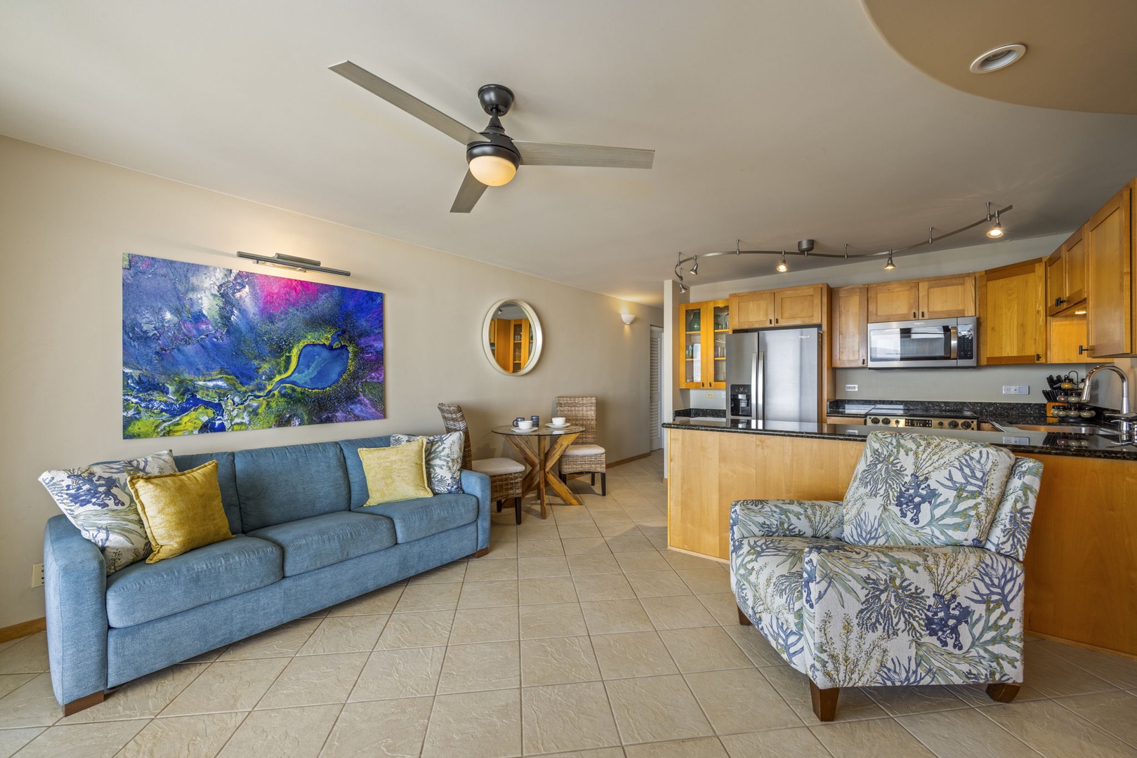 Wailuku Vacation Rentals, Milowai 310 - The abstract painting faces the kitchen across the room, with the dining table for two set between them.