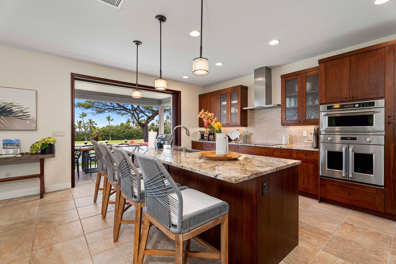 Kailua-Kona Vacation Rentals, Holua Kai #26 - Spacious kitchen with bar seating and an open view to a sunny golf course.