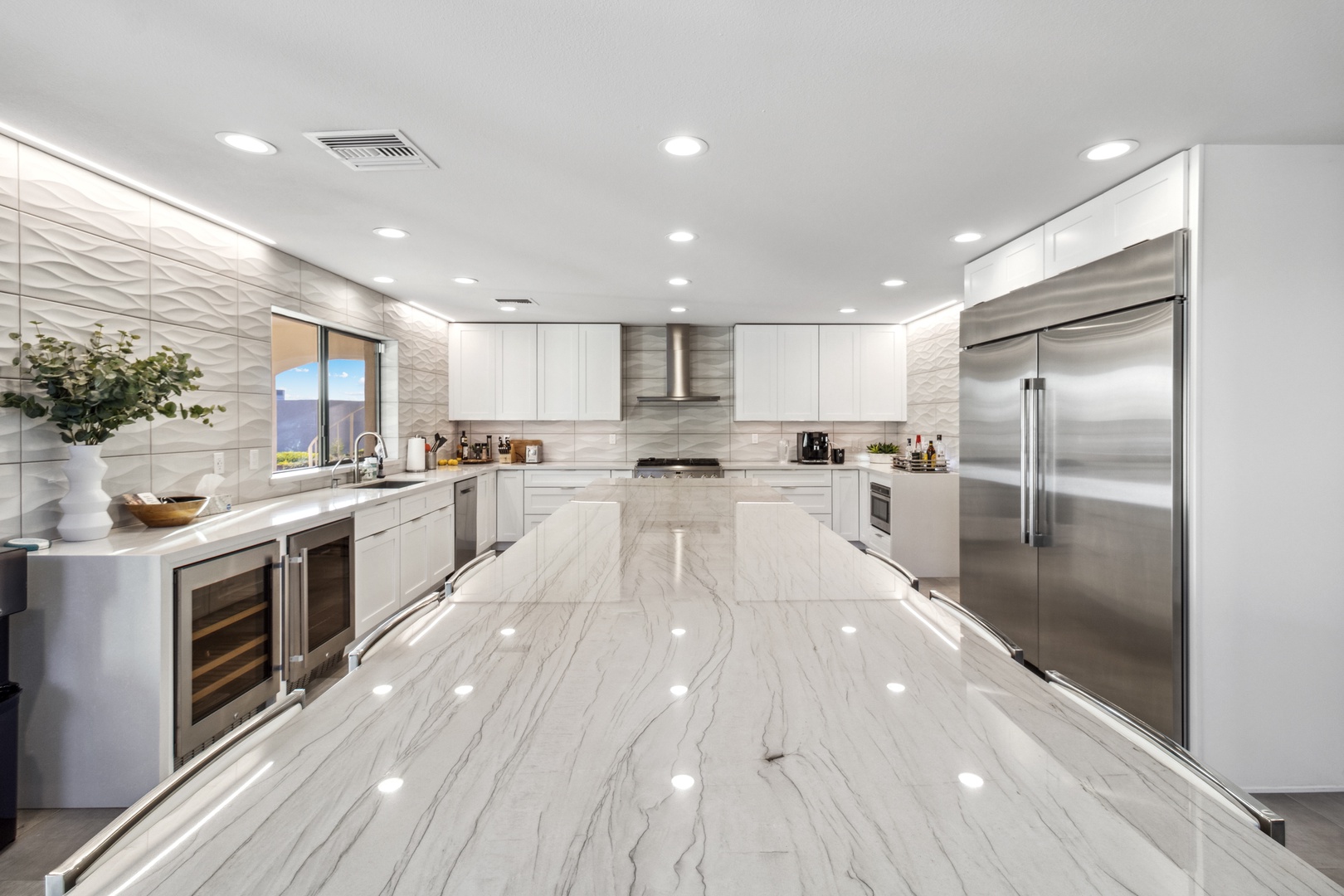 Phoenix Vacation Rentals, Majestic Mountain Views at Piestewa Peak Paradise - There are dual beverage/wine coolers, 72” column fridge/freezer, a professional-style gas range with a drawer microwave, a walk-in pantry, and programmable lighting sconces.