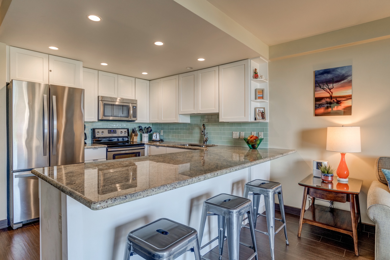 Lahaina Vacation Rentals, Papakea B-105 - The sleek kitchen features granite countertops and modern stainless steel appliances, offering the perfect space to prepare meals and enjoy casual dining at the breakfast bar