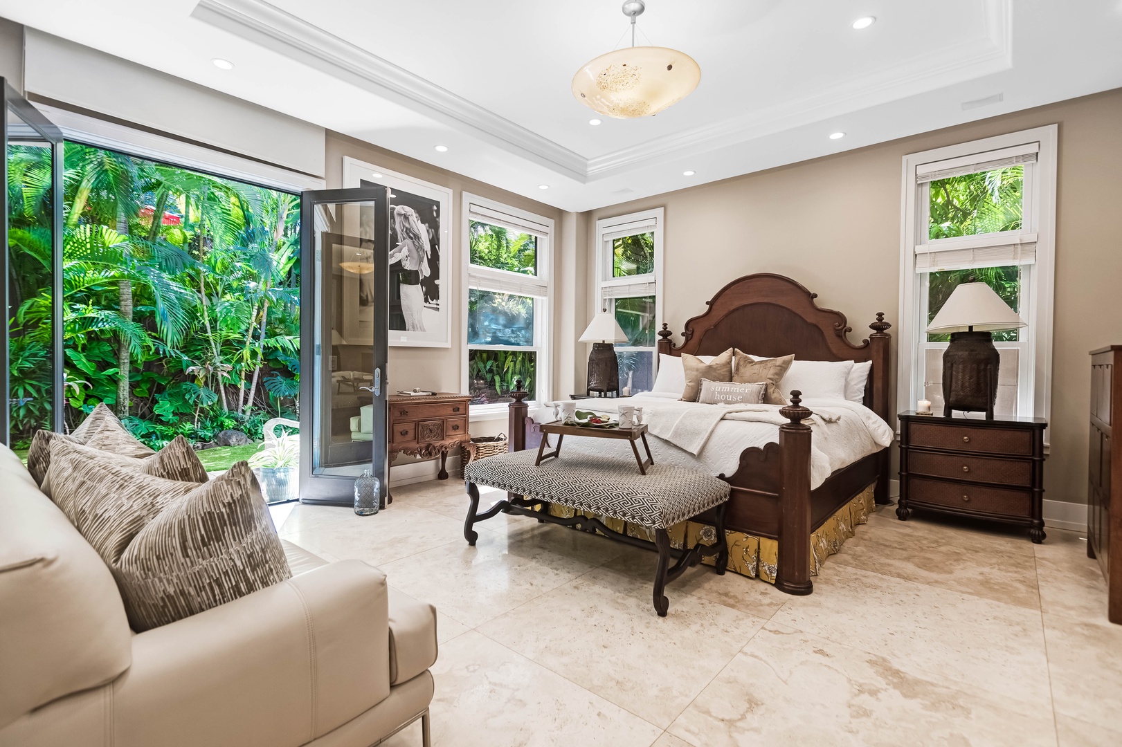 Honolulu Vacation Rentals, Pili Pono - Downstairs primary suite with private lanai and seating area.