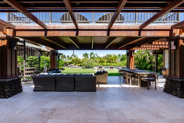 Kamuela Vacation Rentals, Canoe House & Beach Walker at Champion Ridge - Expansive lanai space with comfortable seating, a dining area, and views of the pool and garden.