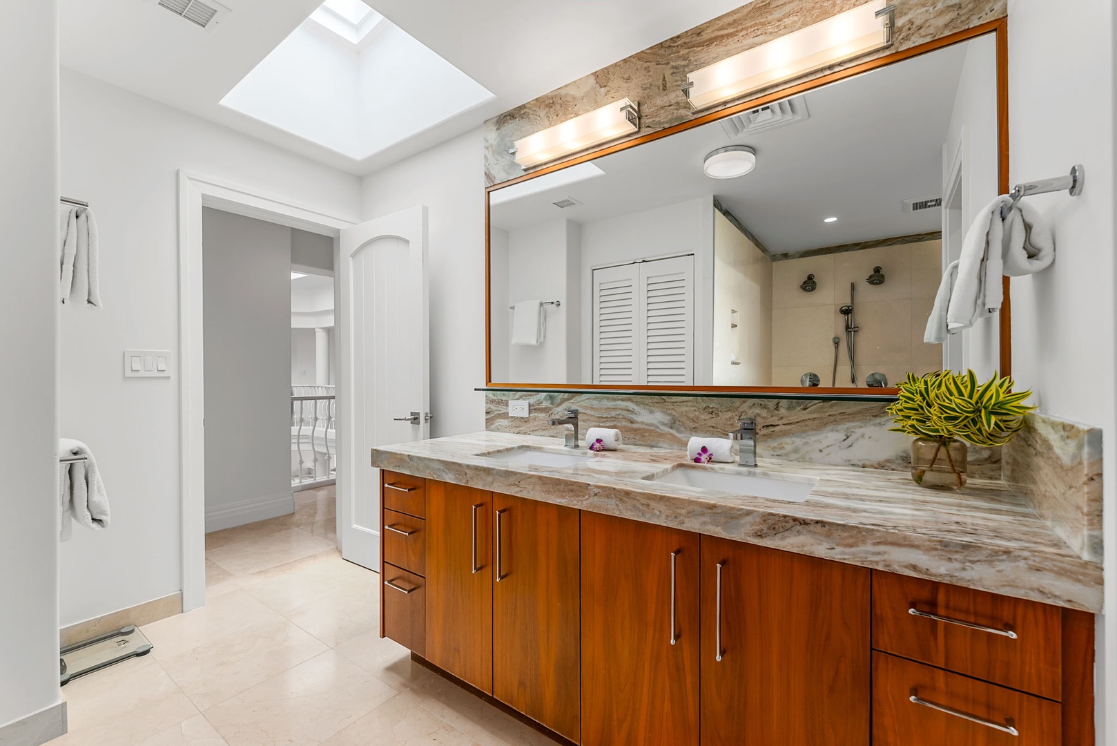 Kailua Vacation Rentals, Lanikai Sunrise Estate - Dual vanity, rich wood cabinetry, and natural light create a serene setting for morning routines.