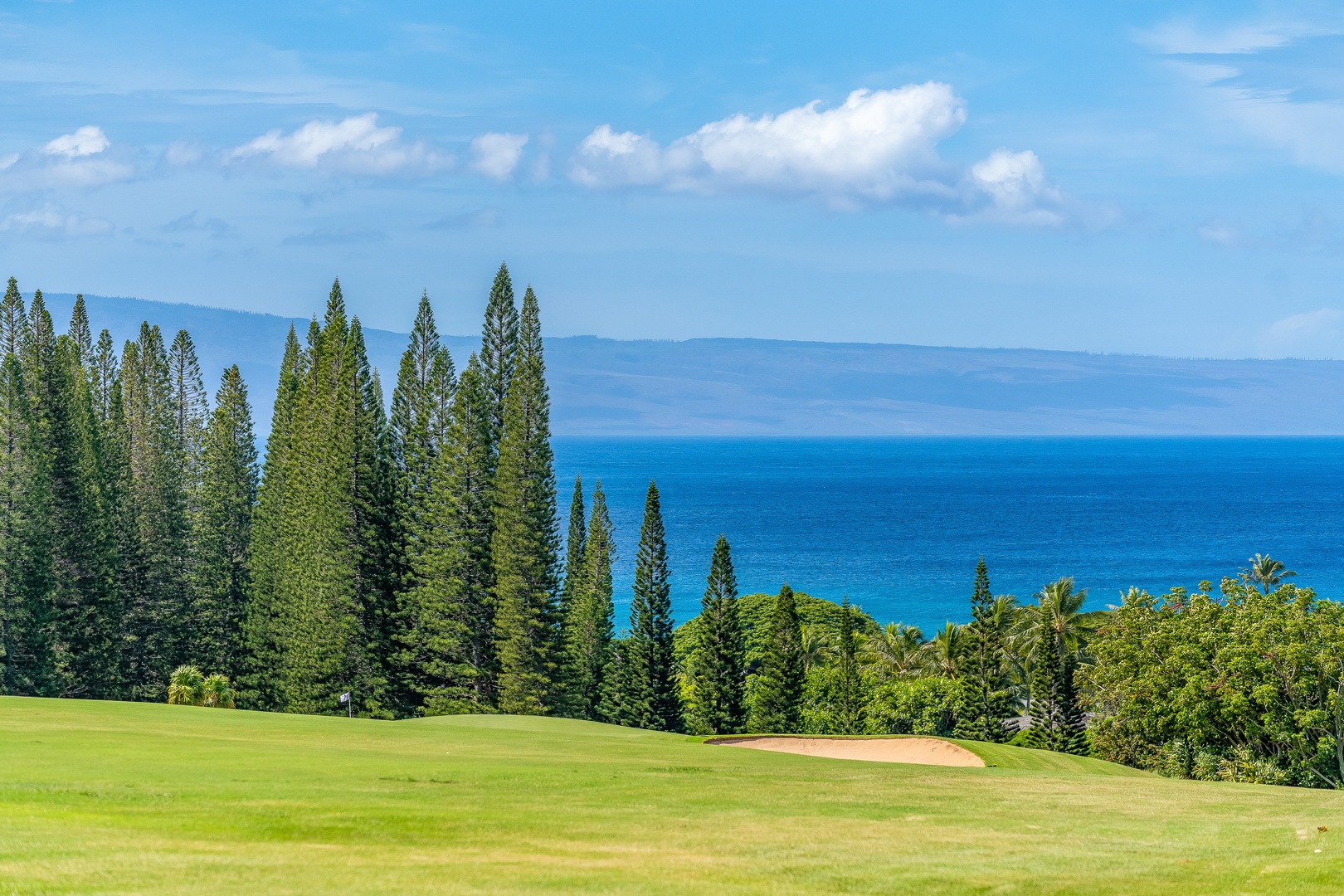 Lahaina Vacation Rentals, Kapalua Ridge 1421 - Nestled at Kapalua Ridge Villas Resort, this lush golf course is set against a peaceful blue sky.