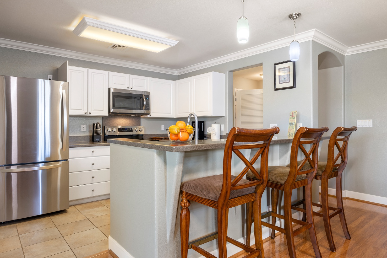 Your fully-equipped kitchen features modern appliances and a breakfast bar where you can enjoy morning coffee or casual meals together.