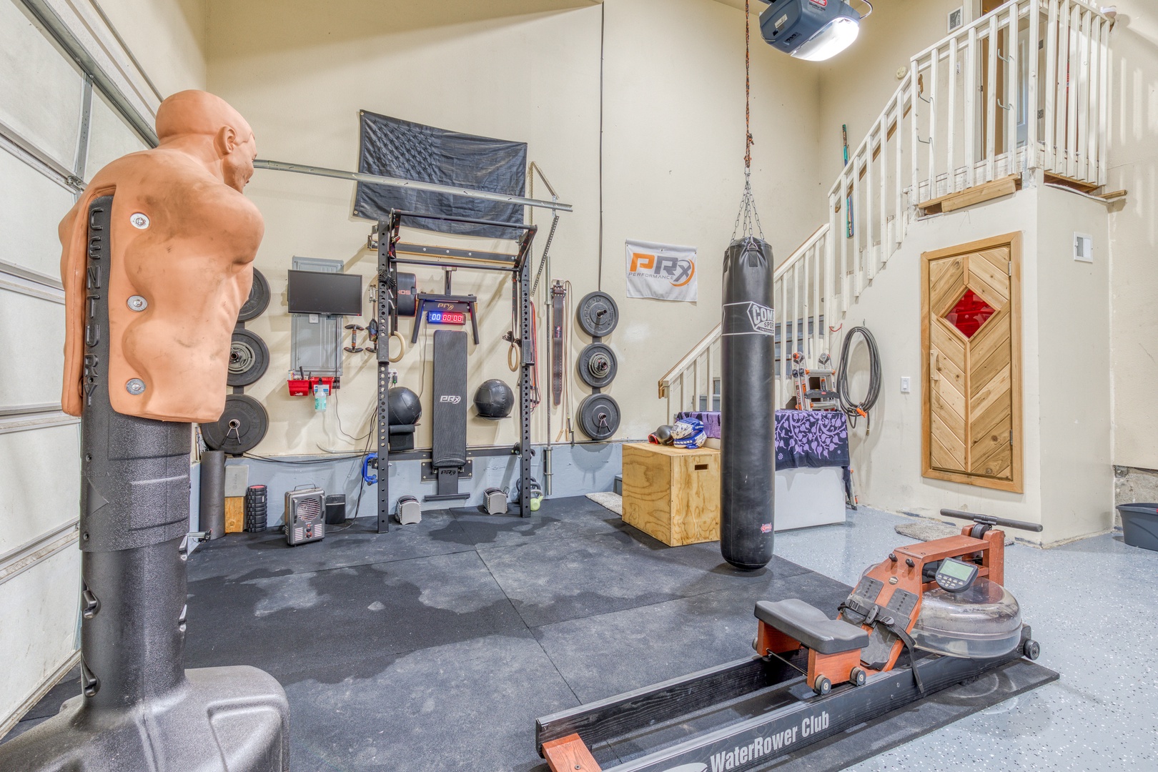 Clackamas Vacation Rentals, Duck Crossing - The garage has a full weight rack, water rowing machine, medicine balls, free weights, and a punching bag for your workout