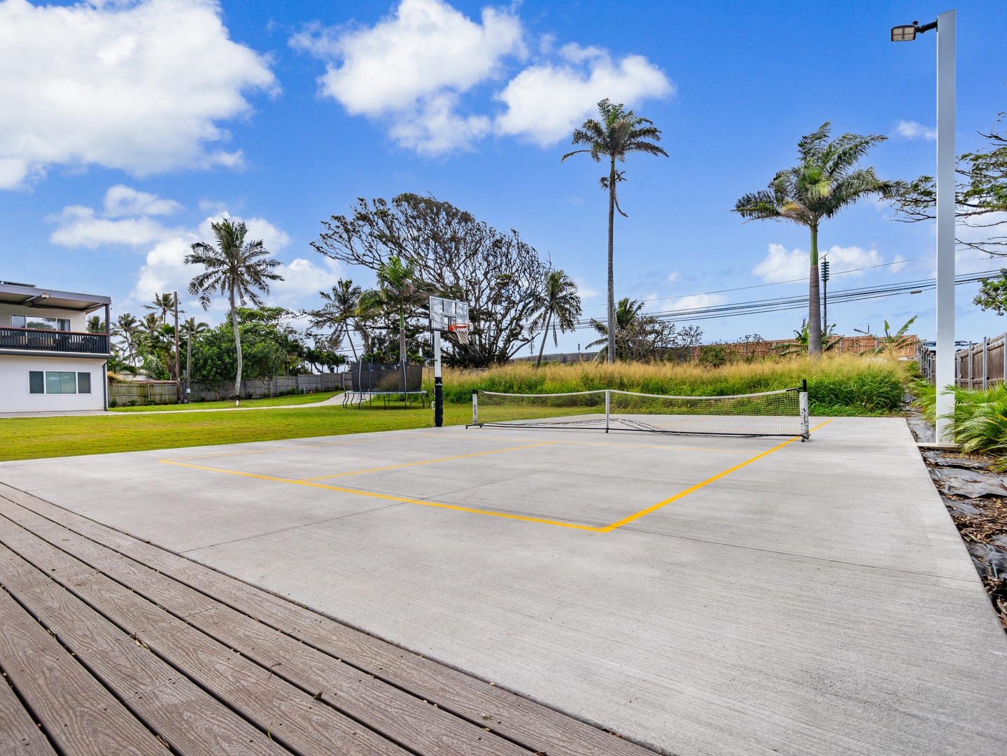 Haleiwa Vacation Rentals, Sunset Beach Island Retreat - A private outdoor sports court provides the perfect setting for a quick game of basketball or pickleball, offering both recreation and fitness opportunities amidst beautiful surroundings.