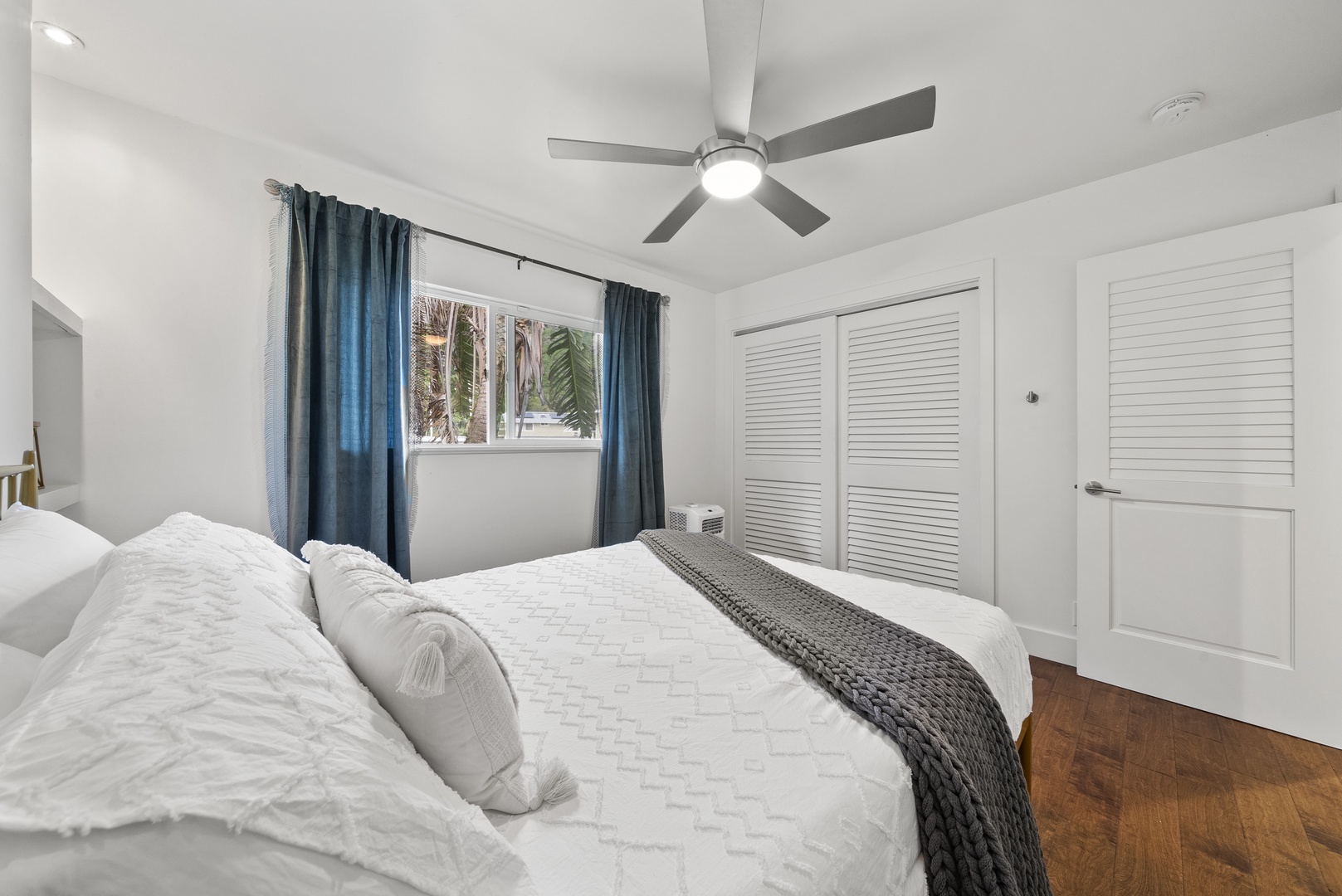 Kaaawa Vacation Rentals, Ka'a'awa Hale - Comfortable bedroom with natural light, cozy bedding, and a relaxing atmosphere.
