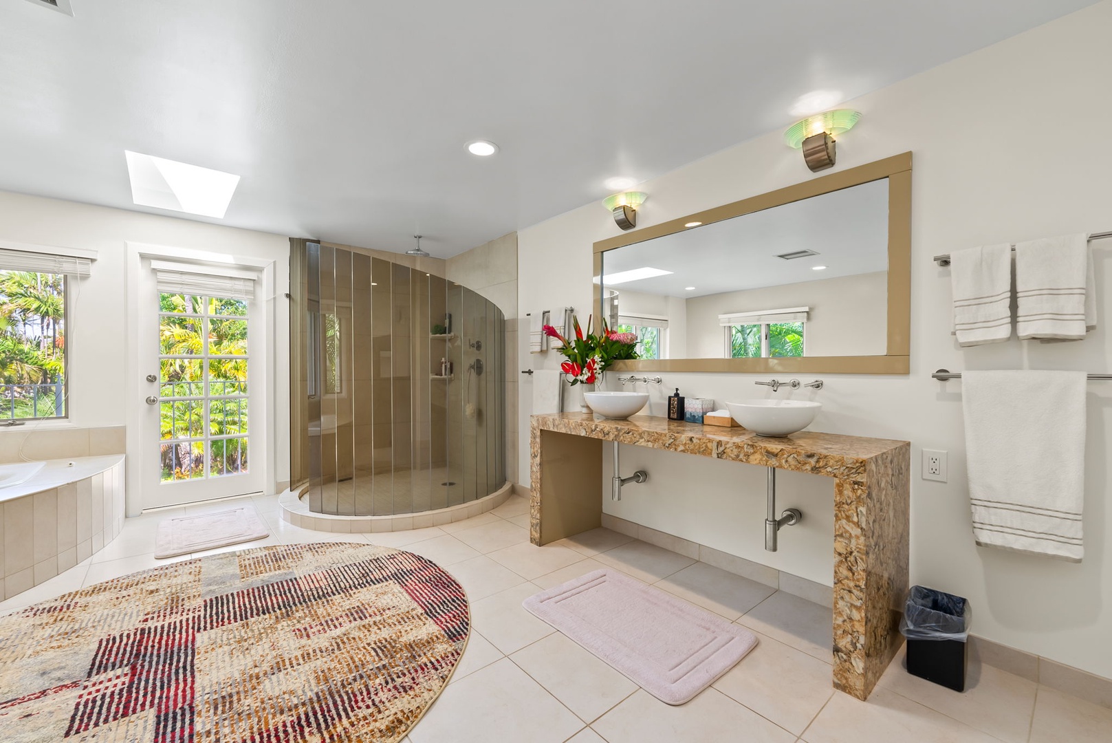 Honolulu Vacation Rentals, Kahala Oasis - Spacious primary bathroom featuring a double vanity, walk-in shower, and garden views for a luxurious experience.