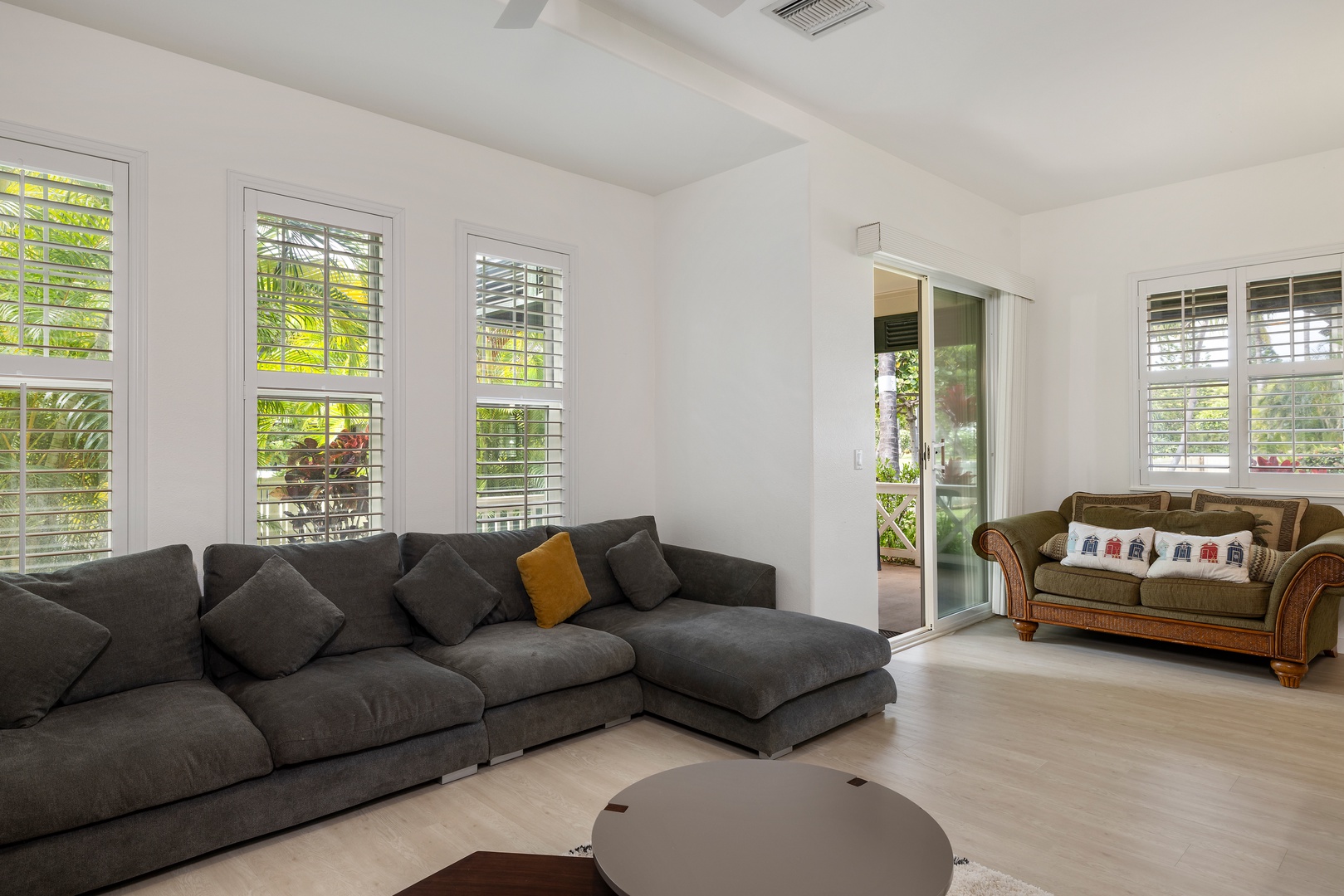 Kapolei Vacation Rentals, Coconut Plantation 1078-3 - Living area with a comfy sectional sofa and access to the patio.