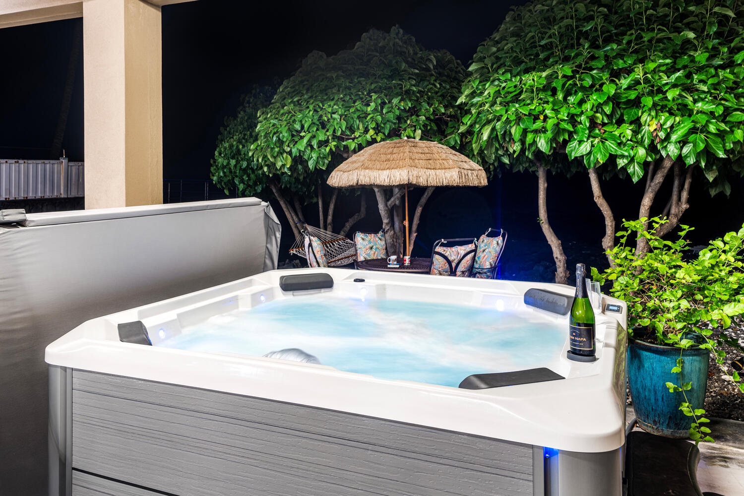 Kailua Kona Vacation Rentals, Kailani Vista - Slide into bubbling bliss after beach adventures; the thatch umbrella, ambient lighting, and crashing waves make every night a spa night.