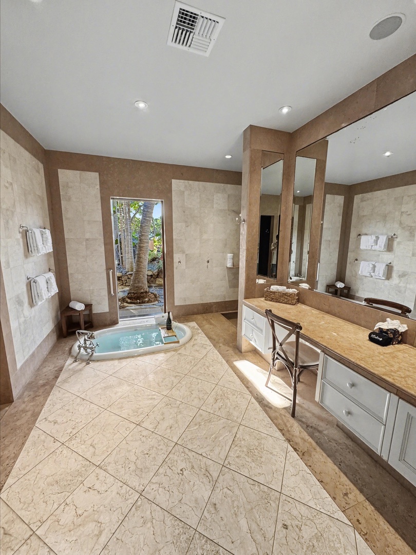 Kailua-Kona Vacation Rentals, Hahalua Bay Villa - Unwind in your luxurious spa-inspired bathroom with a soaking tub overlooking tropical gardens and premium marble finishes.