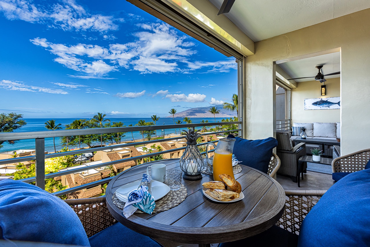 Kihei Vacation Rentals, Kamaole Beach Royal 610 - The private lanai breakfast table's view stretches from the railing to the mountains across the channel.