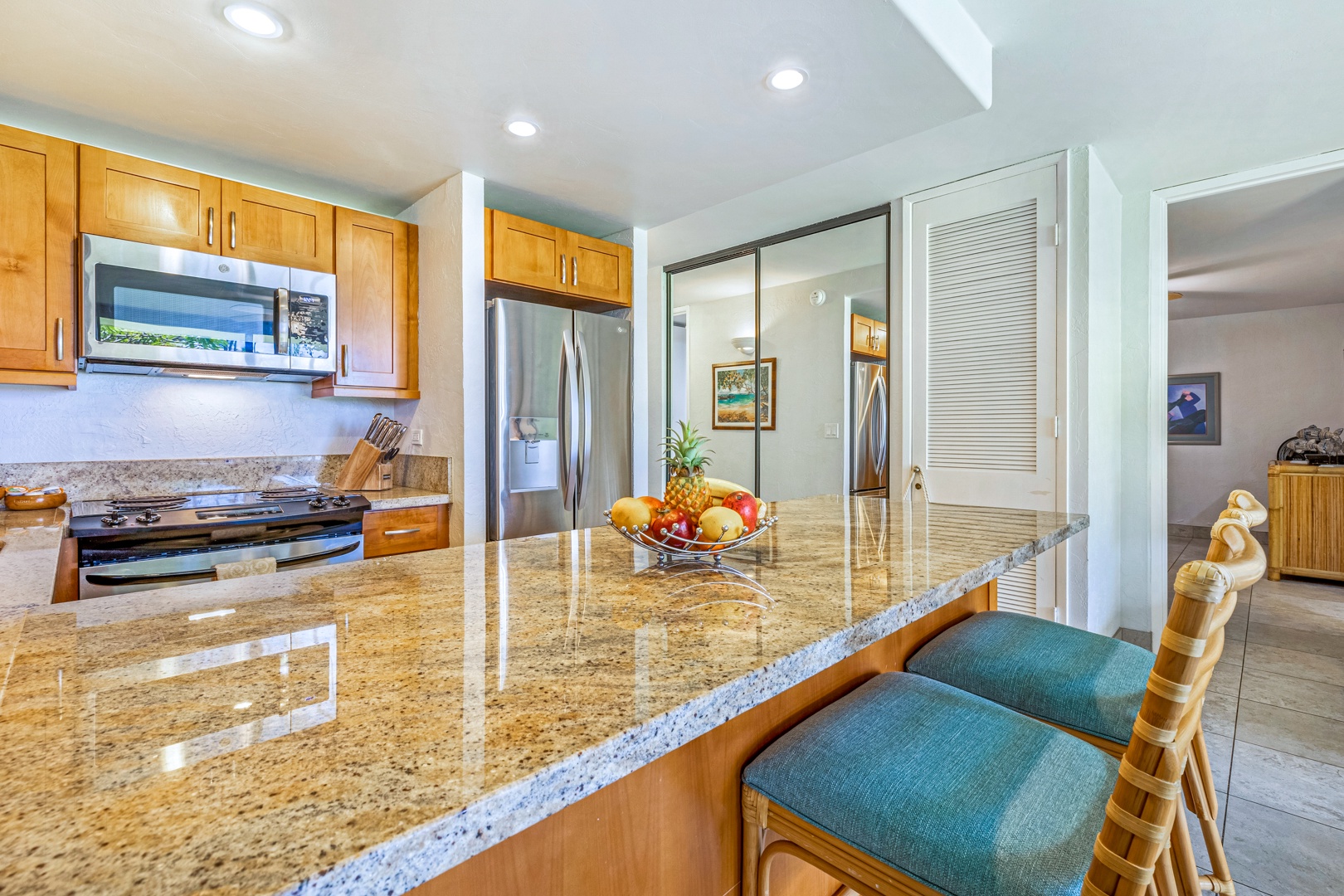 Lahaina Vacation Rentals, Papakea K-105 - The kitchen's spacious granite countertop provides ample space for meal prep or enjoying casual dining at the breakfast bar.