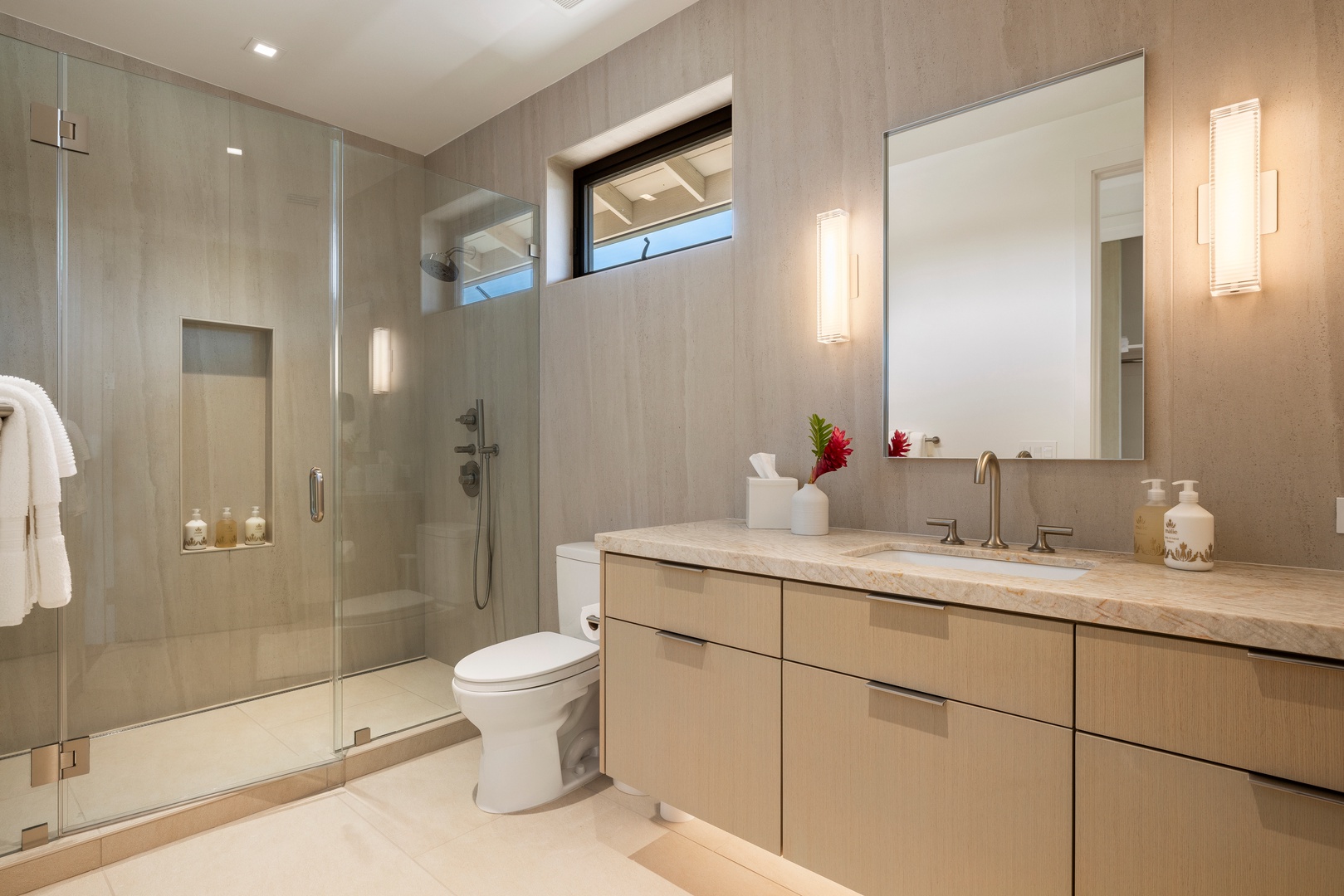 Kamuela Vacation Rentals, 6BD Mauna Lani Lux Golf Estate (5) at One Ocean - Vanity and a glass walk-in shower in a bright guest bath.