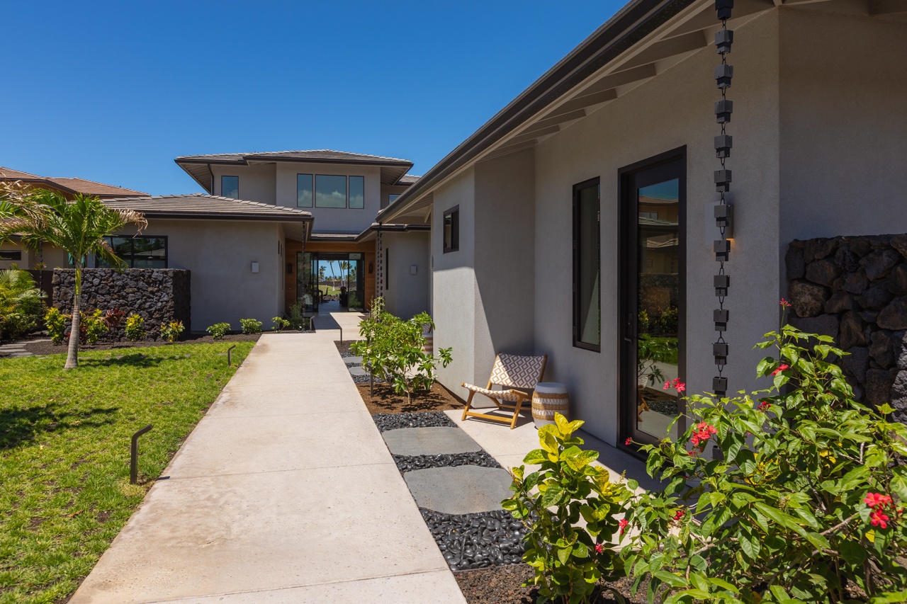 Waimea Vacation Rentals, 5BD Mauna Lani Lux Golf Estate (4) at One Ocean - This inviting pathway leads to a modern home nestled in a lush, landscaped setting, emphasizing clean lines and contemporary architecture.