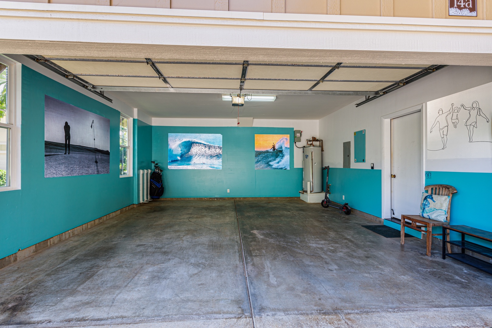 Princeville Vacation Rentals, Pualani Villa - Spacious garage with surf-inspired decor, extra seating, and room for gear or activities.