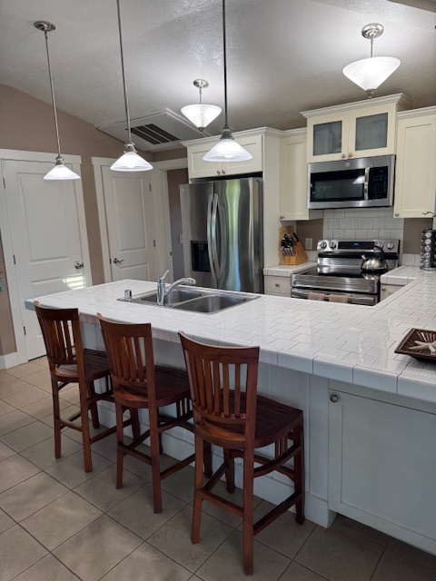 Princeville Vacation Rentals, Pili Aloha - Open kitchen featuring a breakfast bar, good for 3.